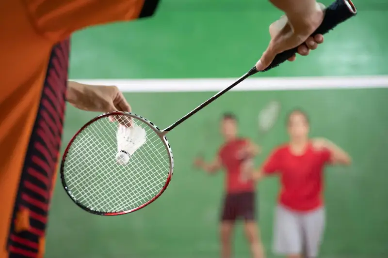 badminton-player-holding-shuttlecock-ready-serve-scaled.jpg